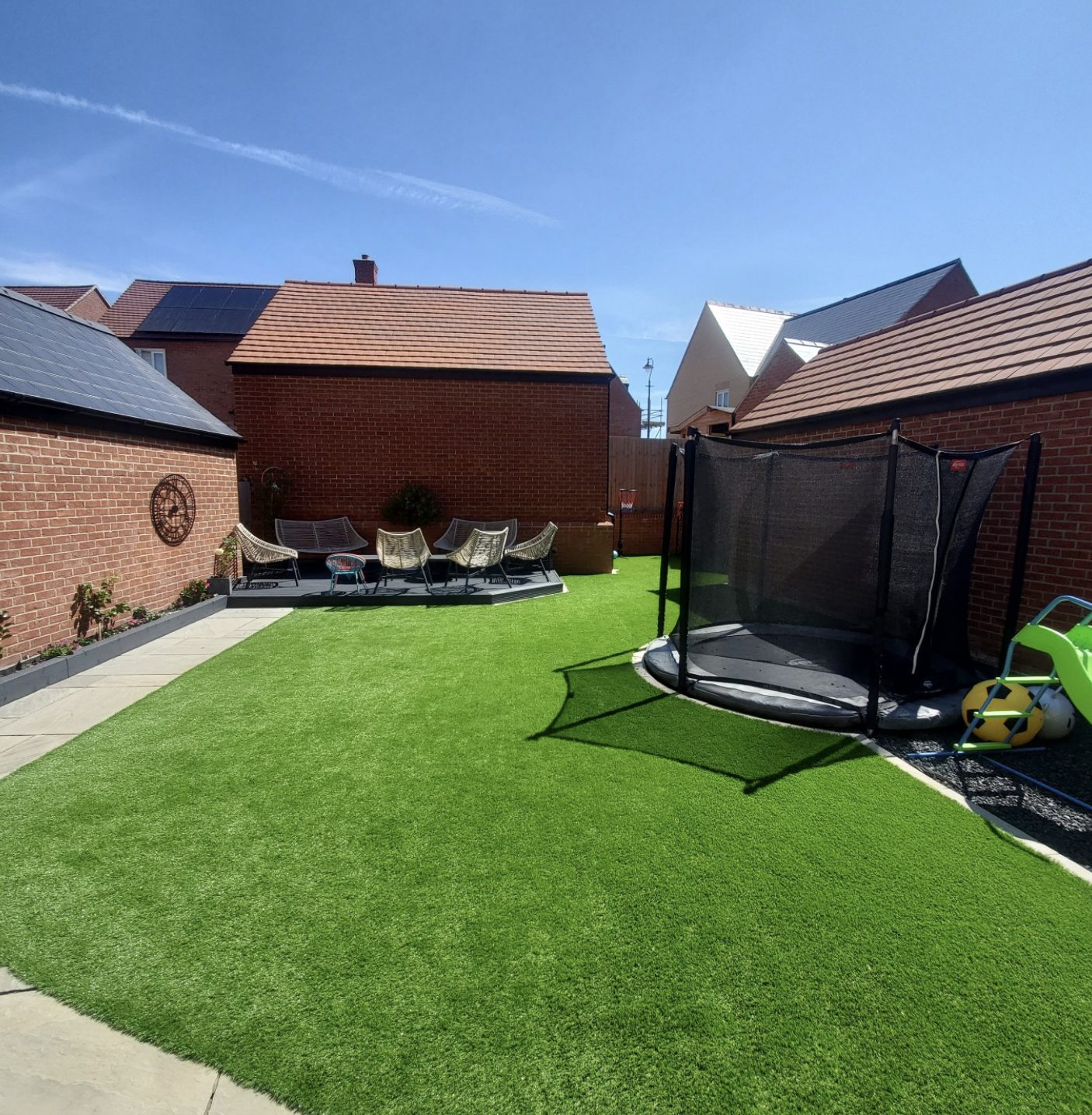 Artificial grass family lawn with a sunken trampoline