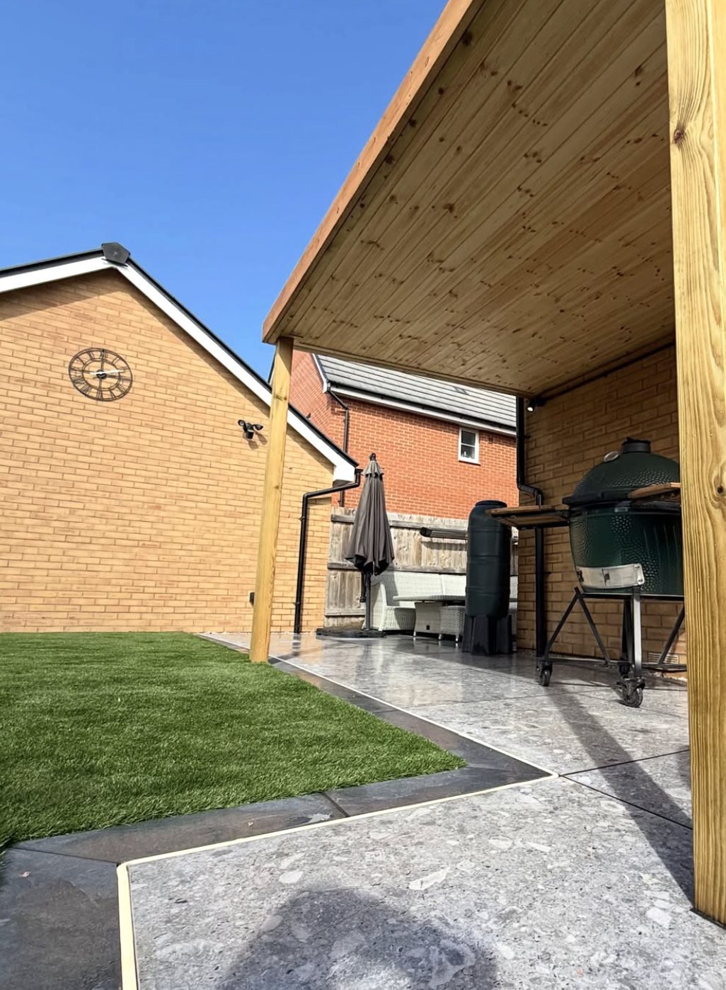Timber canopy over a paved outdoor kitchen area